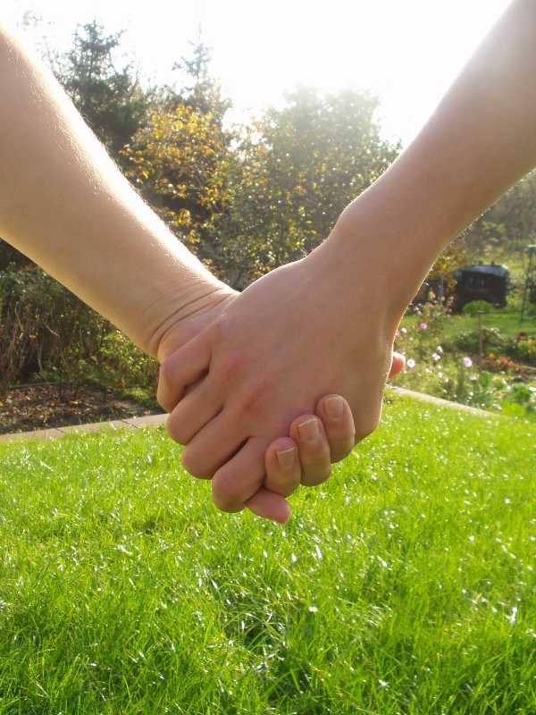 zwei Menschen halten Hände